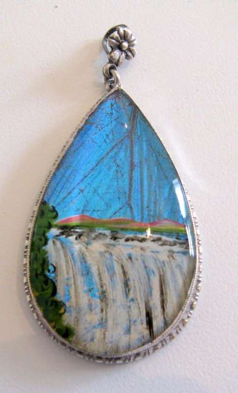 A VINTAGE SILVER BUTTERFLY WING PENDANT.