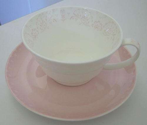 A PRETTY PASTEL PINK AND WHITE TEACUP AND SAUCER (A)