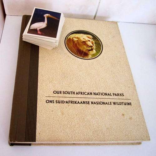 A CIGARETTE CARD ALBUM AND THE CIGARETTE CARDS.