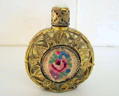 A GLASS AND  BRASS FILLIGREE PERFUME BOTTLE