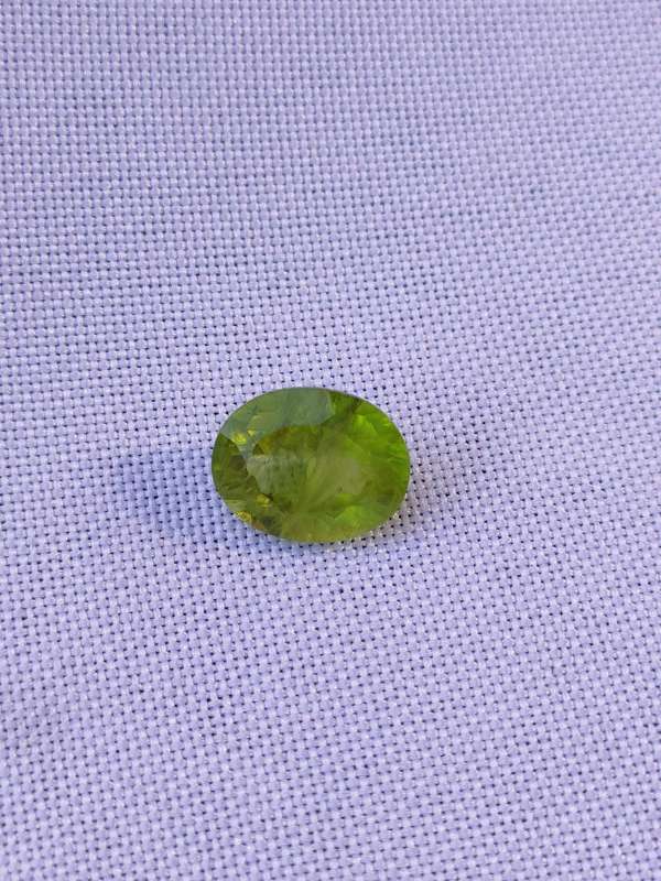 Peridot: - 10 x 8 x 5.25 mm natural mined oval cut stone - 3.02 ct