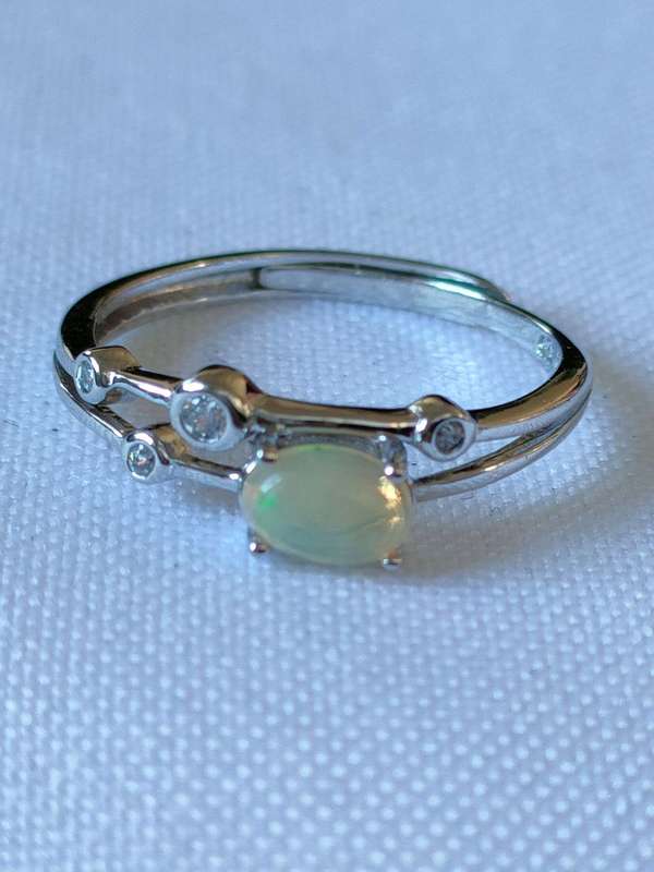 Sterling Ethiopian Opal and White Topaz ring: Size: Adjustable Weight: 0.80.ct+