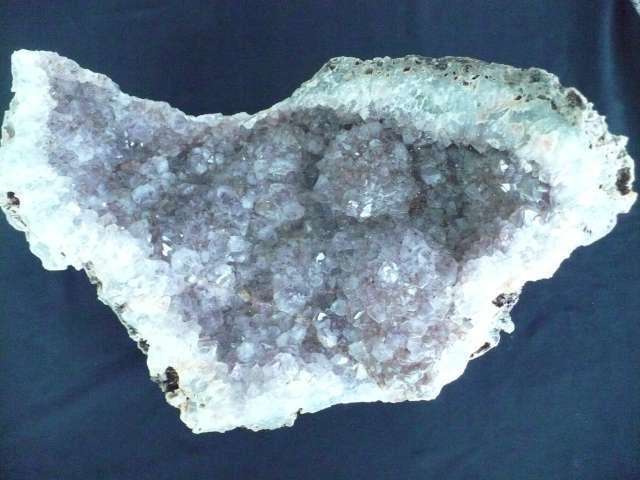 LIGHT  AMETHYST CRYSTAL IN A BED OF QUARTZ