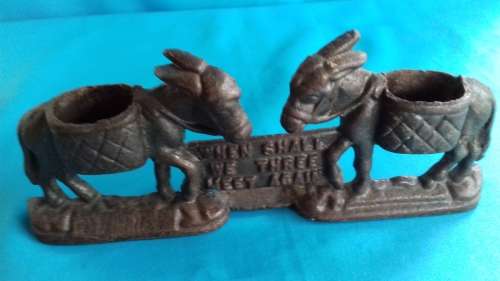 PAIR OF MULES    CAST IRON DOOR STOPPER