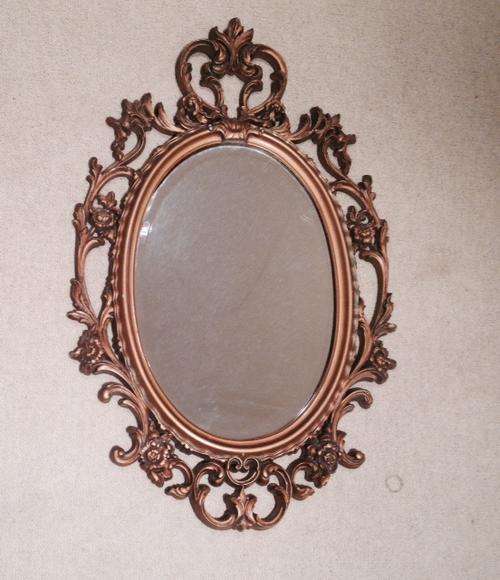 Ornate gold oval mirror