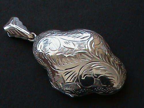 SOLID STERLING SILVER LOCKET....