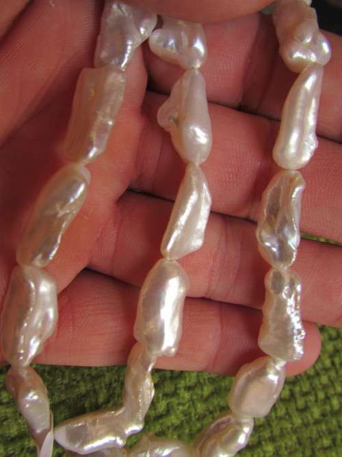 LARGE WHITE BIWA PEARLS.  SIZE APPROX 1.5 CM LONG.  41 CM LONG STRING.
