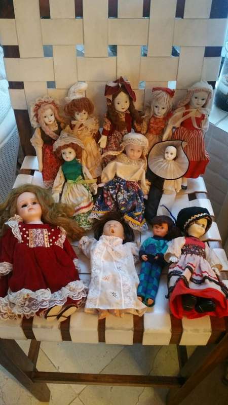 A Collection of 12 Vintage doll, 9 Porcelain and 3 Plastic