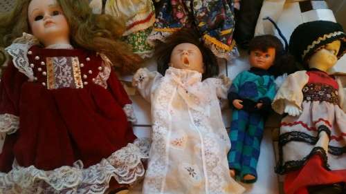 A Collection of 12 Vintage doll, 9 Porcelain and 3 Plastic