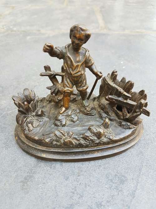 A C1900 Parcel Gilt Bronze Casting of a Child in a Landscape with Vesta Holder and Striker