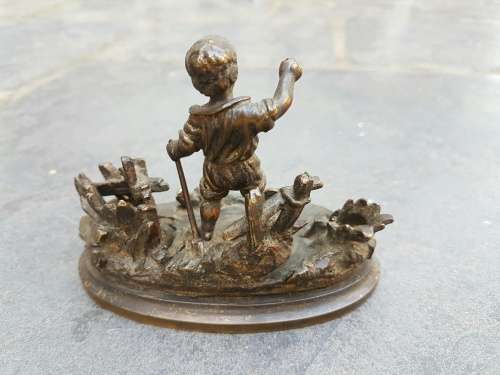 A C1900 Parcel Gilt Bronze Casting of a Child in a Landscape with Vesta Holder and Striker