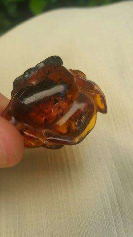 A Chinese Amber Pendant in the Form of a Peach and Insect