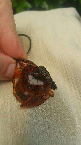 A Chinese Amber Pendant in the Form of a Peach and Insect