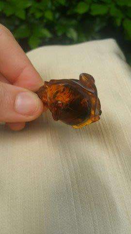 A Chinese Amber Pendant in the Form of a Peach and Insect