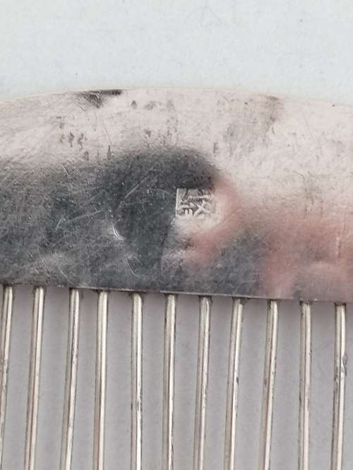 A Pair of Chinese Silver Export Hair Combs With Repousse Peacock Pattern