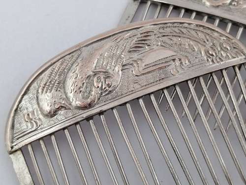 A Pair of Chinese Silver Export Hair Combs With Repousse Peacock Pattern