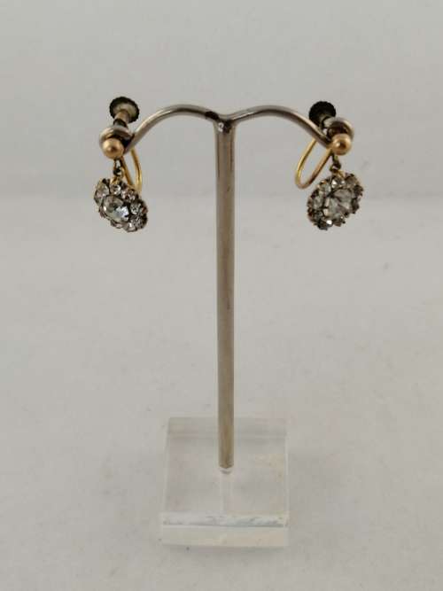 A vintage pair of brass and rhinestone screw back earrings