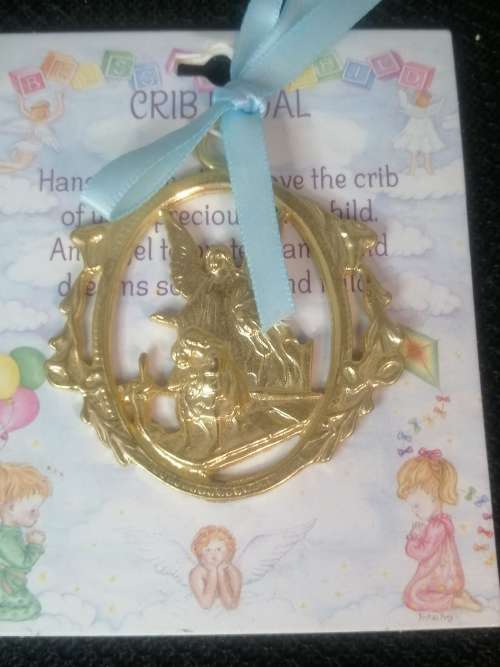 A GOLD TONE CRIB MEDAL