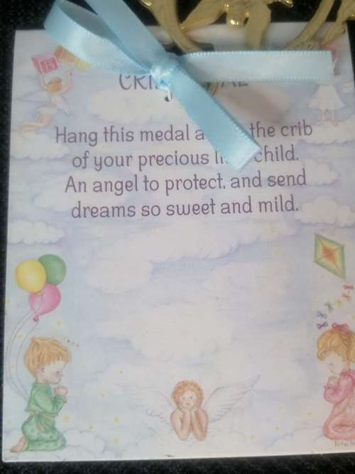 A GOLD TONE CRIB MEDAL