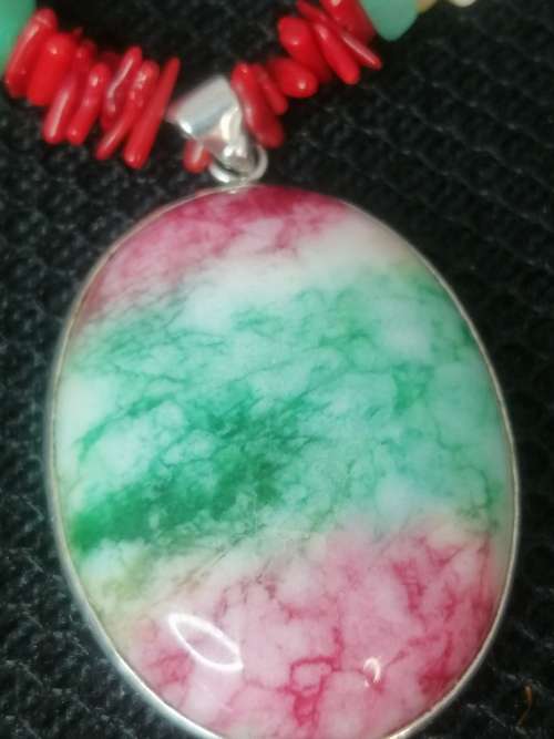 PRETTY GREEN PINK AND WHITE OVAL STONE? PENDANT ON A CORAL ?? AND SHELL CHAIN.