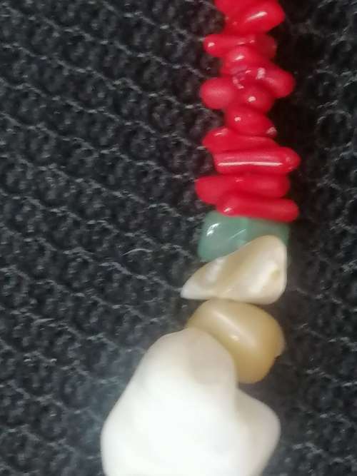 PRETTY GREEN PINK AND WHITE OVAL STONE? PENDANT ON A CORAL ?? AND SHELL CHAIN.