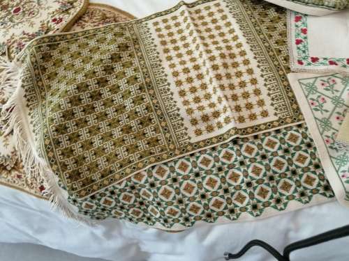 A SELECTION OF ANTIQUE TABLEWARE SOME OF WHICH ARE EMBROIDERED