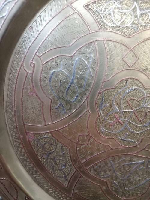 A BEAUTIFUL ARABIC BRASS TRAY WITH RELIEF WORK IN COPPER AND SILVER