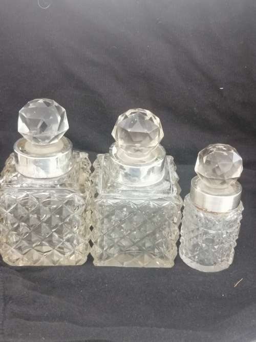 THREE CRYSTAL PERFUME BOTTLES WITH STERLING SILVER COLLAR`S