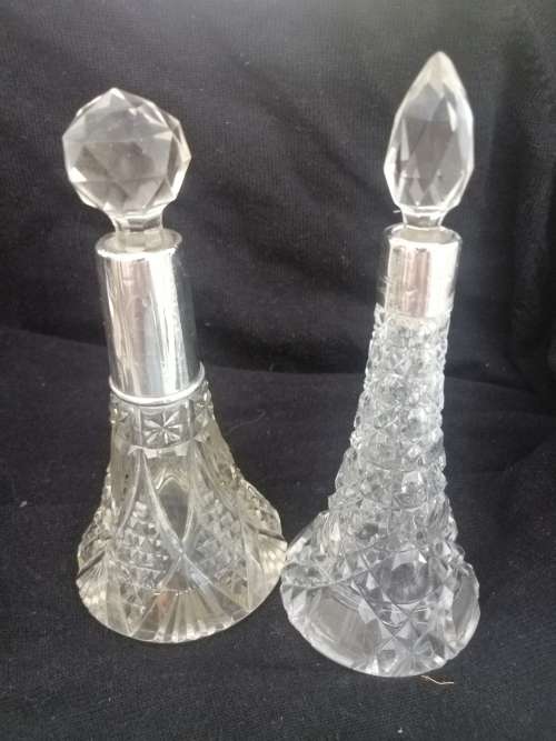 TWO PRETTY CRYSTAL PERFUME BOTTLES WITH SILVER COLLARS
