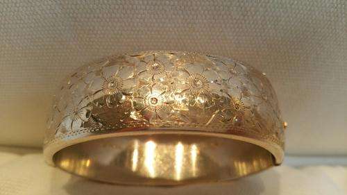 A Sterling Silver Wax Filled Hinged Cuff Bangle Decorated with Engraved Flowers