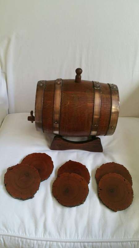 An Oak Wine Barrel with Brass Detail  Wooden Tap and Stand and 6 Wooden Coasters