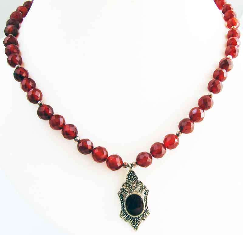 FACETED CARNELIAN NECKLACE WITH SILVER, MARCASiTE AND CARNELIAN PENDANT ON.