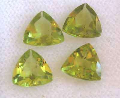 4 pieces of 5.90 mm trillion cut Peridot , T, W. 2.60 ct.