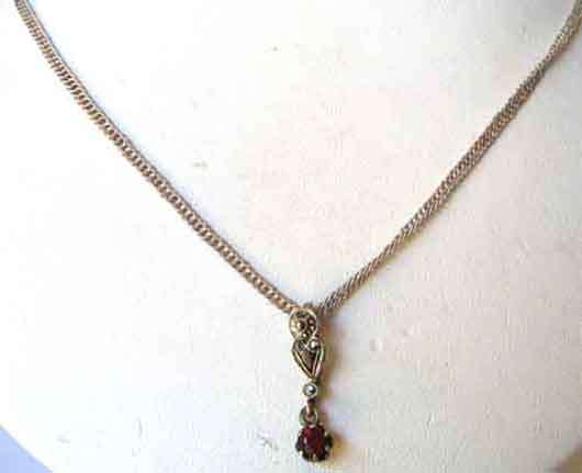 Clasic , Sterling Silver chain and garnet pendant on.