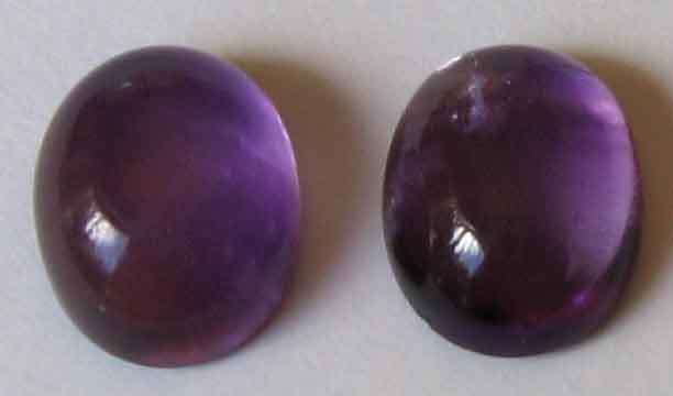 2 pieces of  10.00 x 8.00 mm oval cabachon cut amethysts, T, W.   5.77 ct.s