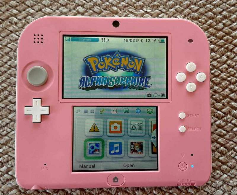 pink nintendo 2ds console with  original charger and carry case with memory card