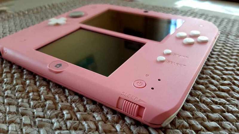 pink nintendo 2ds console with  original charger and carry case with memory card