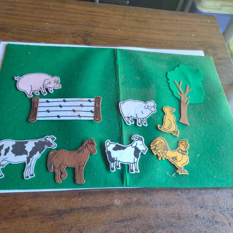 Big green felt board with felt farm animals.