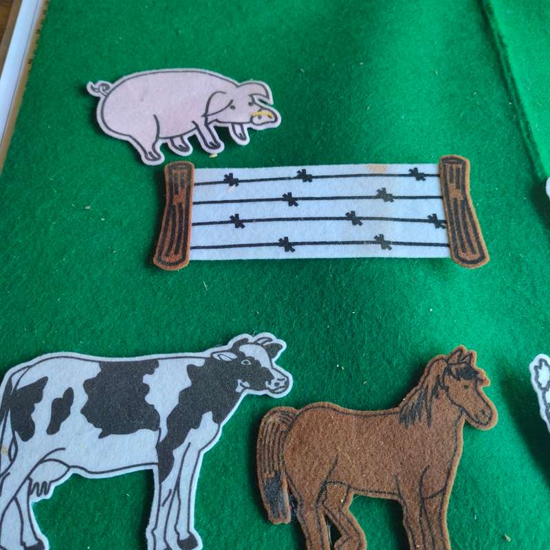 Big green felt board with felt farm animals.