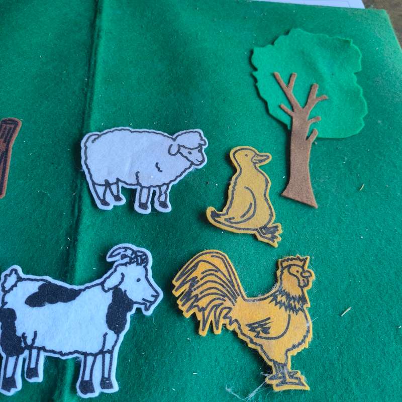 Big green felt board with felt farm animals.