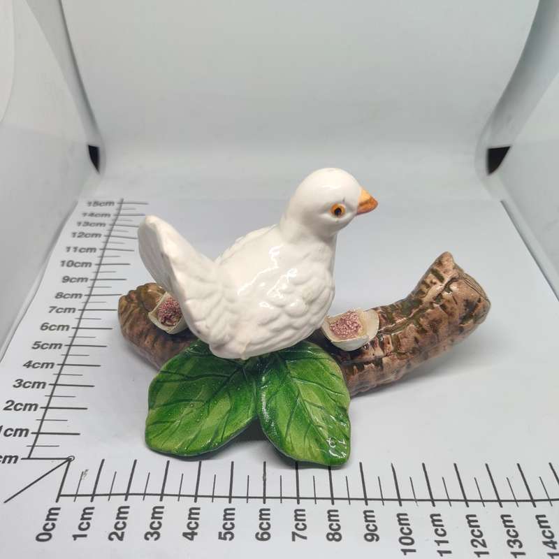 Little white dove on a log figurine.