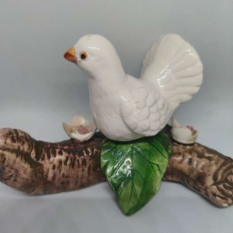 Little white dove on a log figurine.