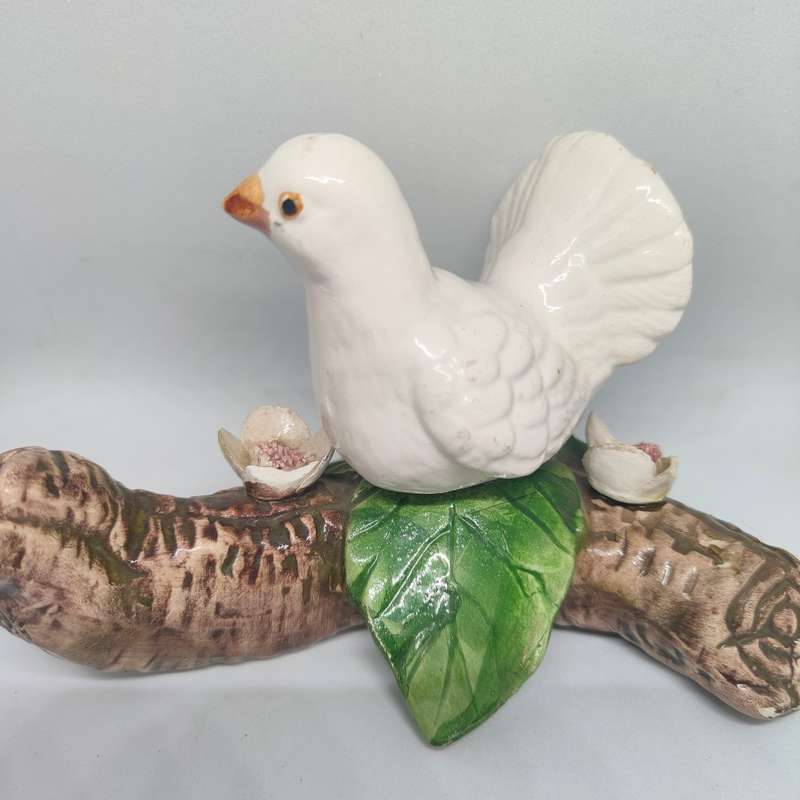 Little white dove on a log figurine.