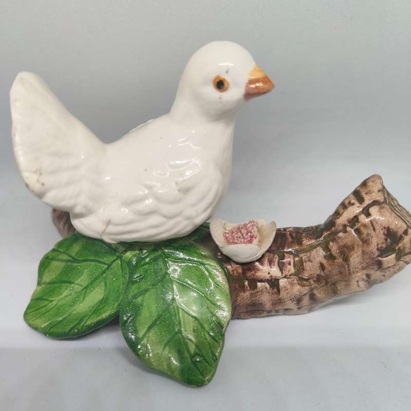 Little white dove on a log figurine.