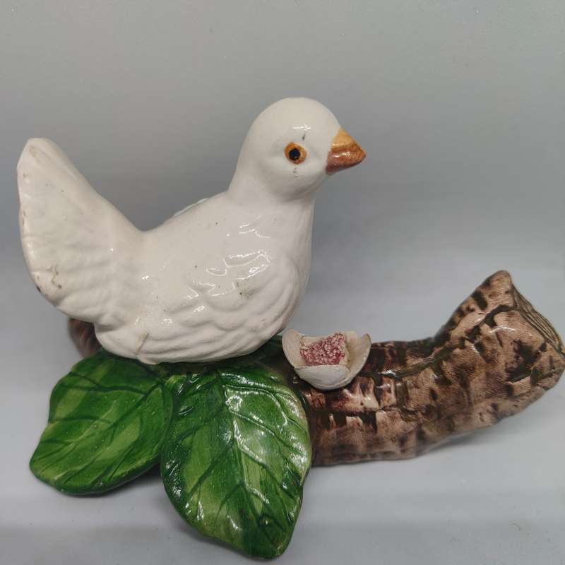 Little white dove on a log figurine.