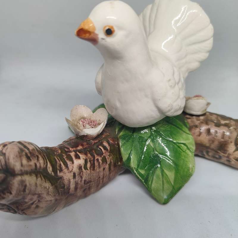 Little white dove on a log figurine.