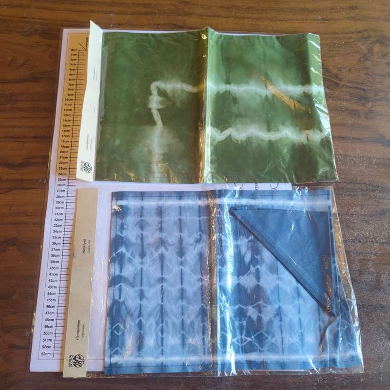 Two sealed tie-dye placemats