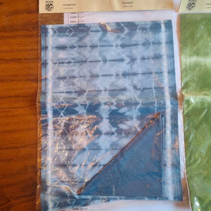 Two sealed tie-dye placemats
