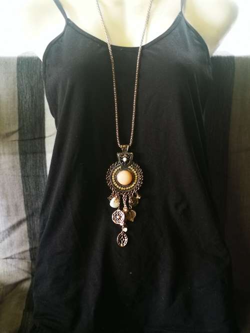Beautiful necklace with bulky pendant and charms