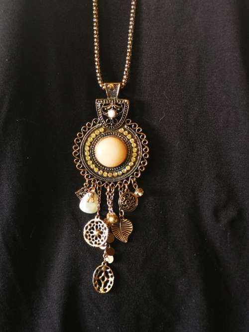 Beautiful necklace with bulky pendant and charms